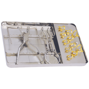 Stainless steel dental instrument tray with pliers, clamps, and gold-tipped rings arranged on the right side