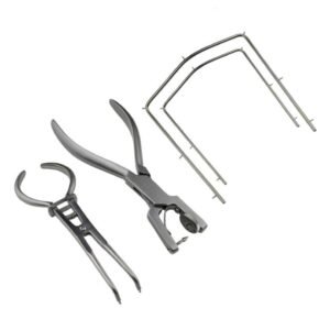 Dental extraction kit with pliers, forceps, and dental retractors laid out in a row.