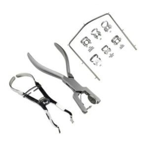 Dental extraction forceps and pliers with a small instruction sheet on a white background, showing a dental instrument set at rest.